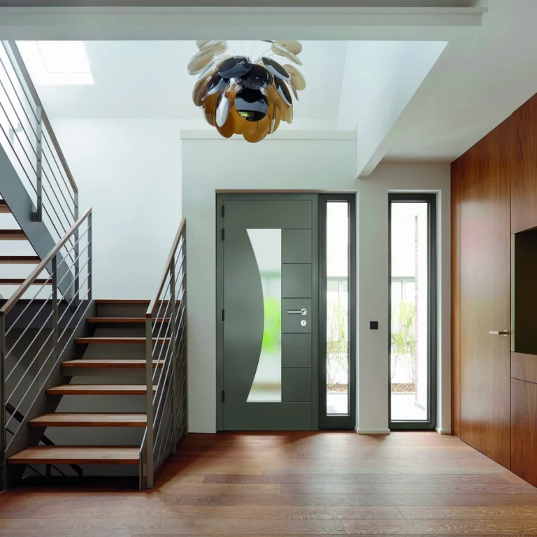 Modern hallway with aluminium designer door featuring curved frosted glass and matching side panels.
