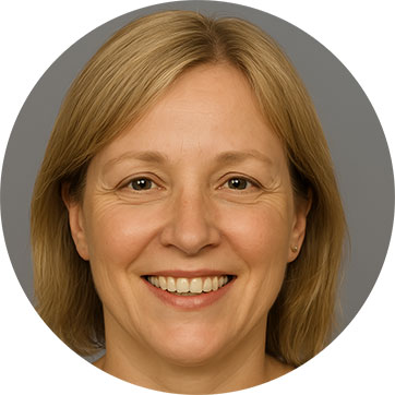 Smiling woman with short blonde hair against a neutral grey background.
