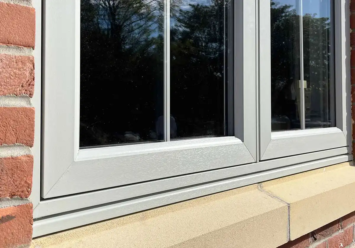 Close-up of modern grey flush-fit uPVC window with double glazing.