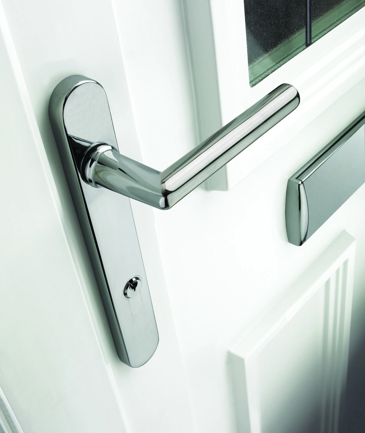 Close-up of chrome door handle and letterbox on a white uPVC front door.
