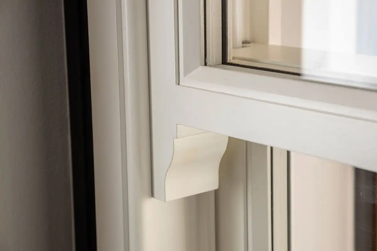 Close-up of a timber vertical sliding sash window with decorative horn detail