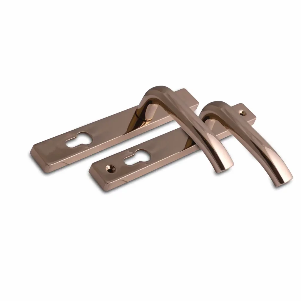 Gold-finish architectural door handles with rectangular backplates and keyhole cutouts.
