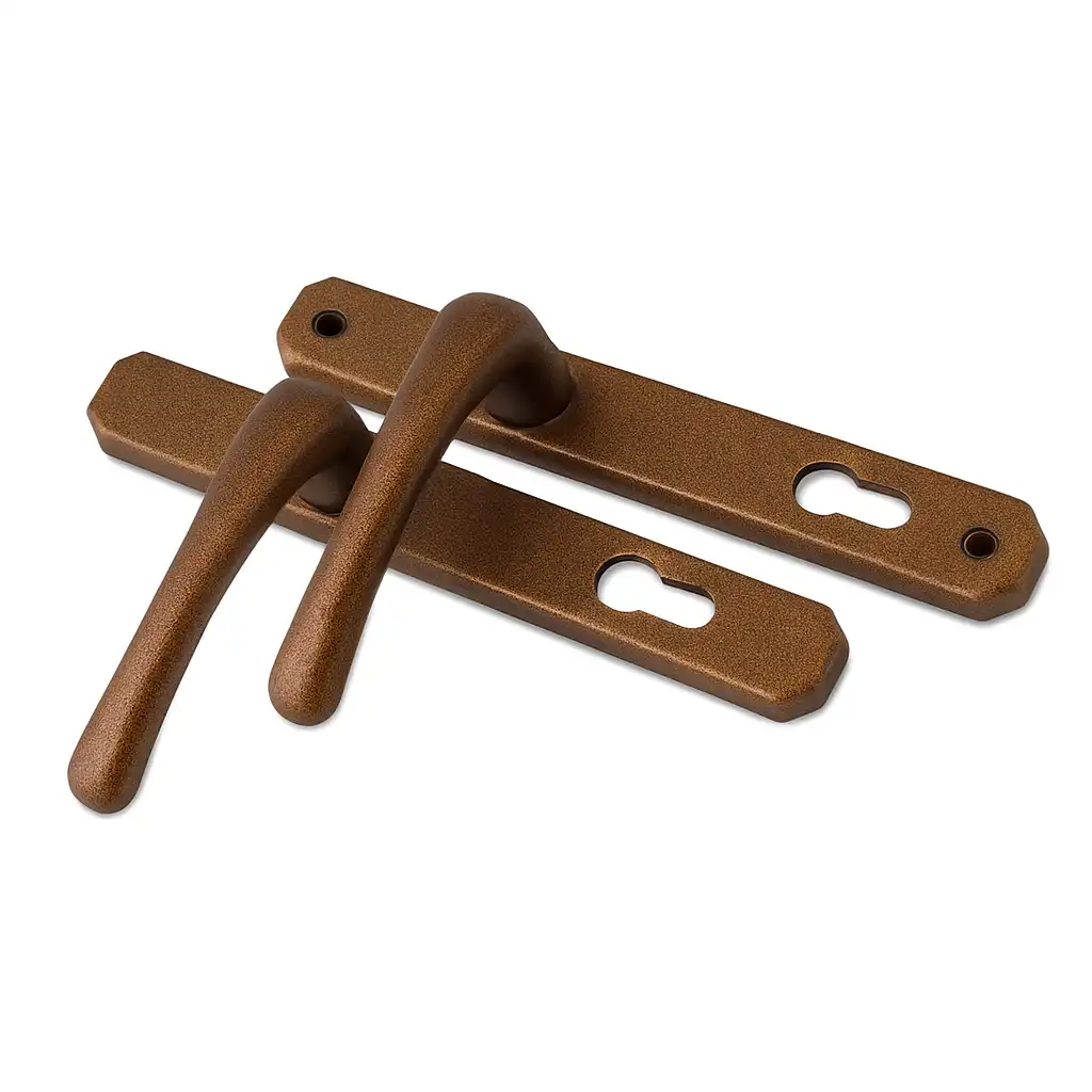 Bronze-finished heritage door handles with long rectangular backplates and keyhole cutouts.