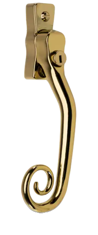 Gold patina monkey tail window handle with curled end and locking mechanism.
